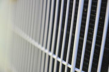 Residential air conditioning unit outdoors with fan and coils