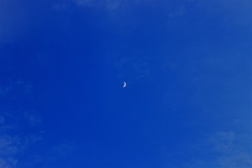 Naklejka na ściany i meble Bright moon on a dark blue sky.