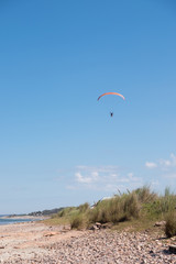 Parasailing over Las Flores Beach, on a very hot day during the summer at Maldonado, Uruguay.