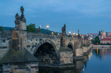 Fototapeta na wymiar Charles bridge with stone sculptures and street lights
