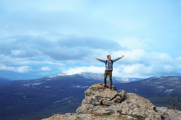 Man in Red Hat on top of the mountain