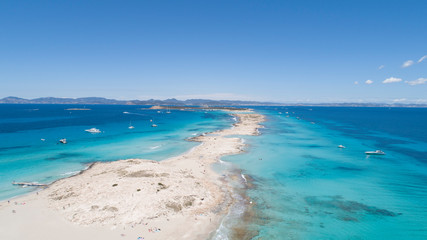 illetas, formentera beach seen from drone with turquoise and crystalline sea and Ibiza in the...