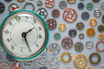 Retro clock and small parts of watch on gray background