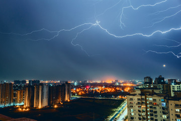 Multiple lighting bolts thunder  during a storm with a dramatic blue sky in noida, delhi India  - Image