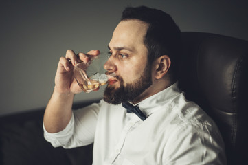 Close up of senior man with whiskey glass . 
