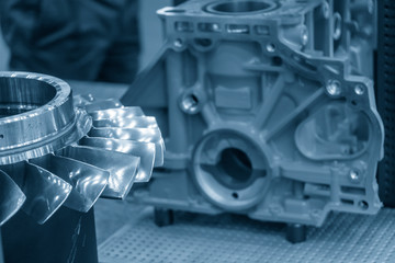 The impeller parts with the cylinder block background. The boats engine manufacturing concept.