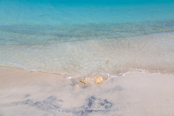 A full frame photograph looking at the turquoise sea lapping a sandy beach, on the Caribbean Island...