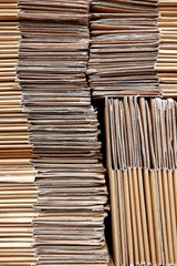 Close up abstract pattern and texture of the old cardboard paper boxes stacked in vertical frame for reuse and recycle concept