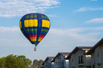 Fototapeta na wymiar Colorful of balloon on blue sky with home village