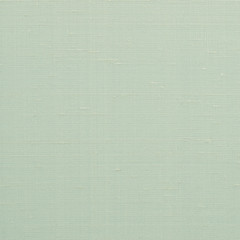 Green cloth texture background of woven cotton linen fabric textile backdrop in pastel light yellow spring lime color