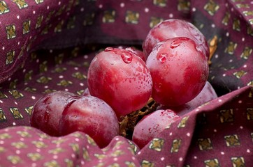 Shot to some grapes on a piece of bordeaux cloth