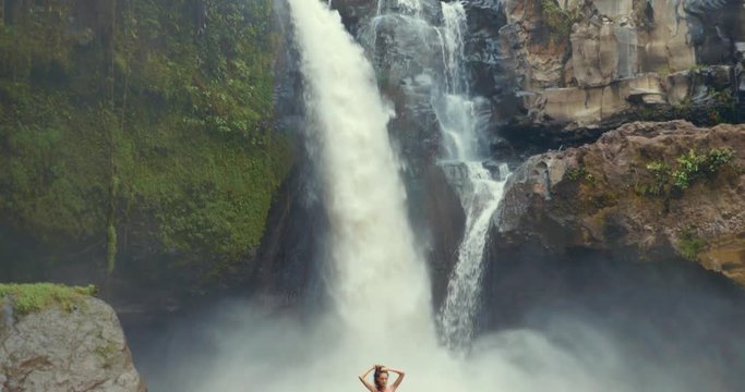  Beautiful girl having fun at the waterfalls in Bali