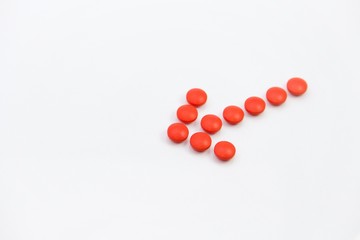 red round pills on a white background