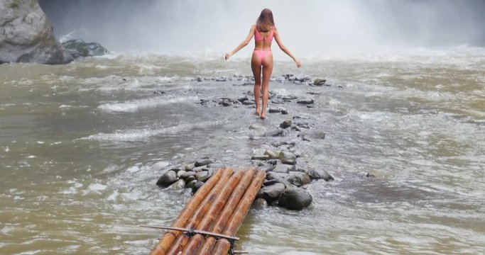  Beautiful girl having fun at the waterfalls in Bali