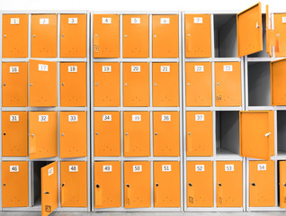 .many orange cabinets, safe deposit boxes with keys for storing things in the supermarket and...