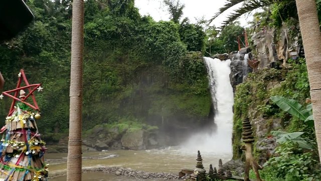Beautiful girl having fun at the waterfalls in Bali. Concept about wanderlust traveling and wilderness culture
