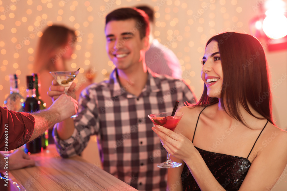 Wall mural Young people with martini cocktails at party