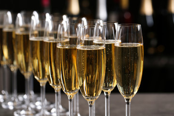 Many glasses of champagne on blurred background, closeup