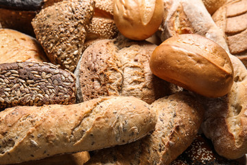 Different kinds of fresh bread as background, closeup