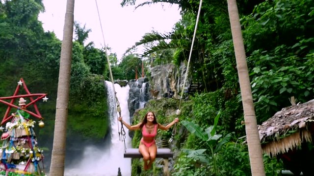 Beautiful girl having fun at the waterfalls in Bali. Concept about wanderlust traveling and wilderness culture