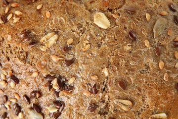 Tasty bread with seeds as background, closeup