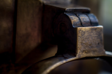 Closeup of a wooden handle on an antique brass samovar. Selective focus.