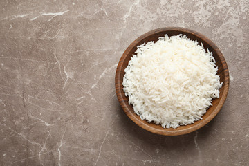Fototapeta na wymiar Plate of tasty cooked rice on color background, top view. Space for text
