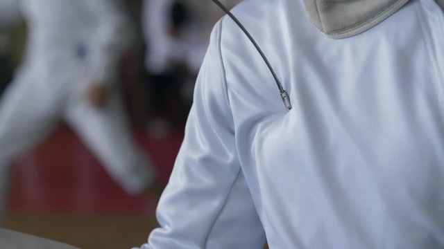 Fencers epee pierces an opponent