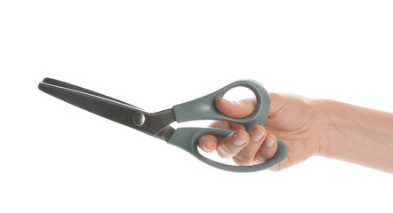 Woman holding pair of sewing scissors on white background, closeup
