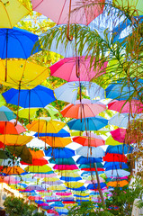 Fototapeta na wymiar Beautiful colorful umbrellas as a decor of the street in Nicosia, Northern Cyprus. The umbrella serves also as a shade and protection against the sun. Captured on a vertical picture
