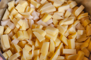 peeled raw potatoes in a saucepan