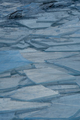 Broken ice piled up by wave action on shore of Lake Michigan, Michigan, USA.