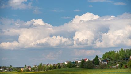 Fototapeta na wymiar Beautiful panoramic view on village with white clouds