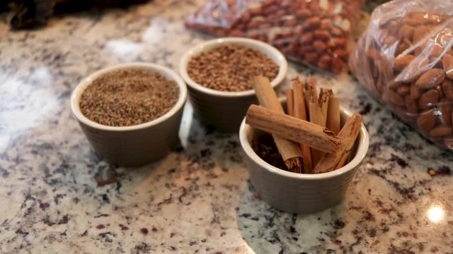 Top view, Close-up. Cloves, pepper grains, almonds and cinnamon on the table. Tipical ingredients of original Mole from Puebla, Mexico. North America. Cooking Traditional recipe