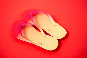Beach flip flop on red background