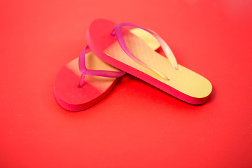 Beach flip flop on red background