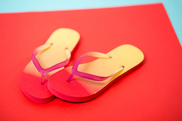 Beach flip flop on red background