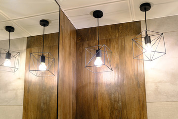 Lighting of the toilet. Pendant lamps are reflected in the mirror.