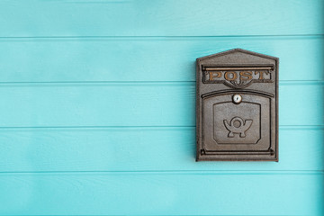 postbox hanging on a blue wood wall