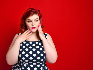 Pin up girl vintage. Beautiful woman pinup style portrait in retro dress and polka dot dress. Studio shot.