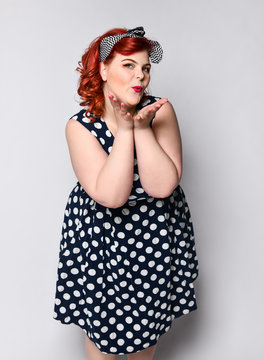 Pin up woman portrait. Beautiful retro female in polka dot dress with red lips and manicure nails and old fashion hairstyle