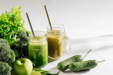 Healthy drink with spinach and green vegetables in jar on white background. Vegetarian food. Detox and diet concept.