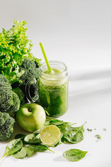 Healthy drink with spinach and green vegetables in jar on white background. Vegetarian food. Detox and diet concept.