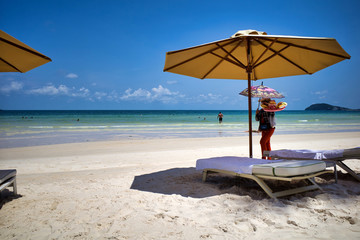 Seller bringing local fruits on beautiful Sao beach with white sand, Phu Quoc island, Vietnam