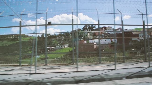 Ceuta, Spain Footage of double barbed wire fence at Moroccan border built to stop migrant inflows into EU, pushback action at border, as seen from vehicle driving by