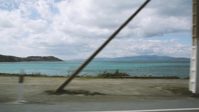 Ceuta, Spain with Turquoise Mediterranean sea off the North African coast as seen from vehicle driving by in Ceuta enclave along the shore - Enclave struggling with irregular migrants from Morocco