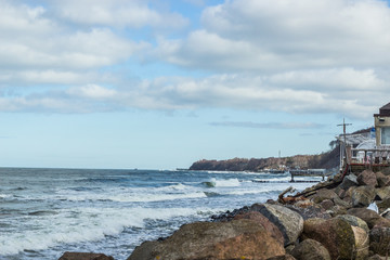 Fototapeta na wymiar Empty beach, waves and dramatic sky at the Baltic sea shore line