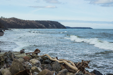 Empty beach, waves and dramatic sky at the Baltic sea shore line