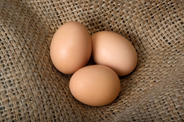 Beautiful crude eggs on burlap. Protein, protein, Top view.