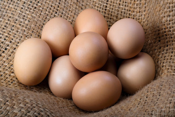 Fresh eggs from a farm on burlap close up. Poultry farm, natural products.